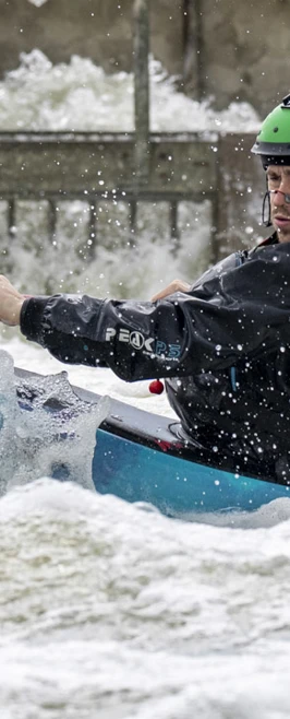 Kayaker in a green helmet paddling through fast-moving whitewater, focused and determined. Kayaker in a green helmet paddling through fast-moving whitewater, focused and determined.